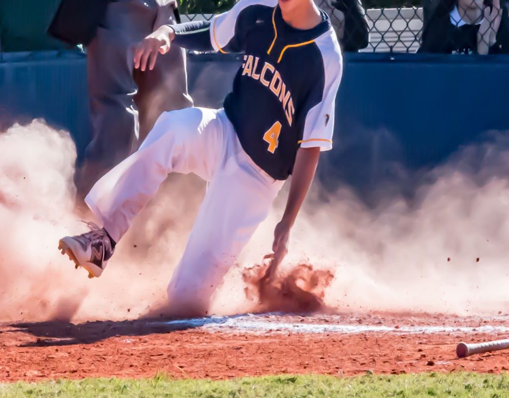 baseball player sliding onto a plate