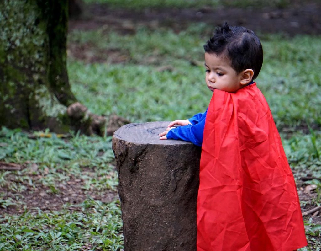 boy wearing red cape