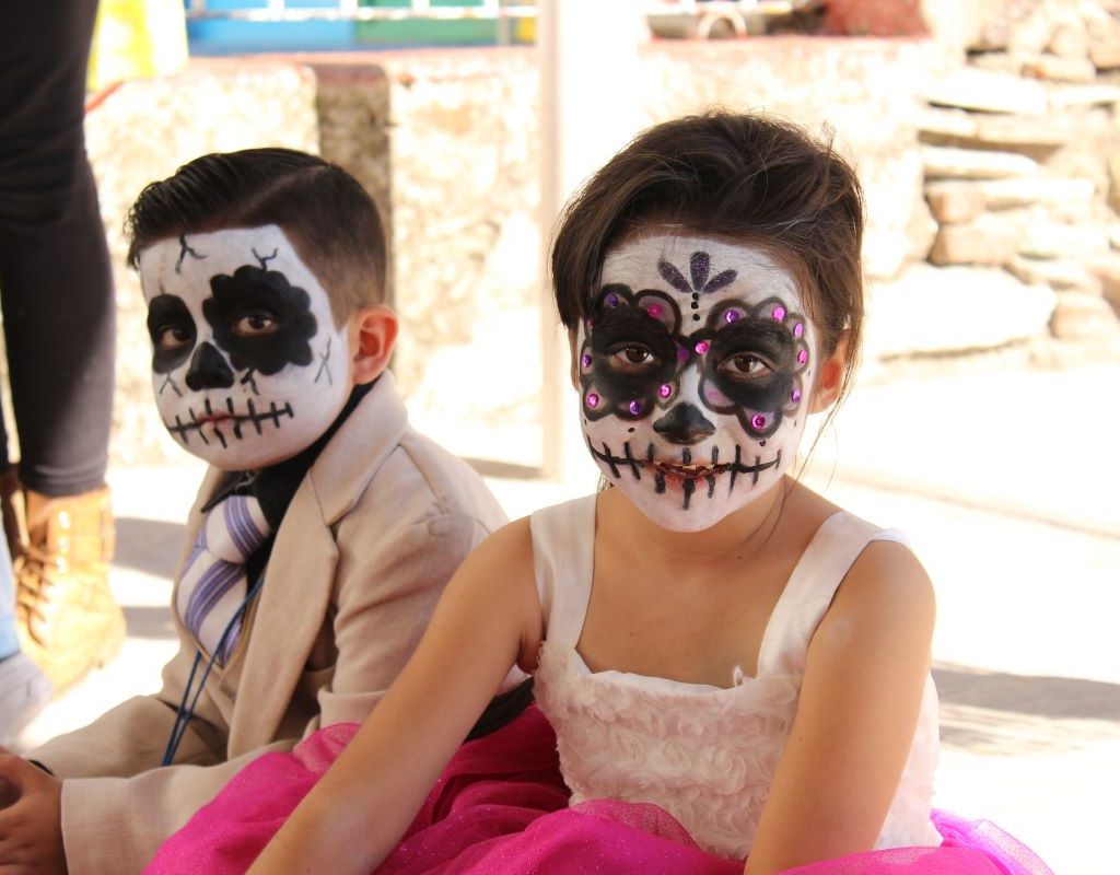 children with faces painted for Dia de los Muertos