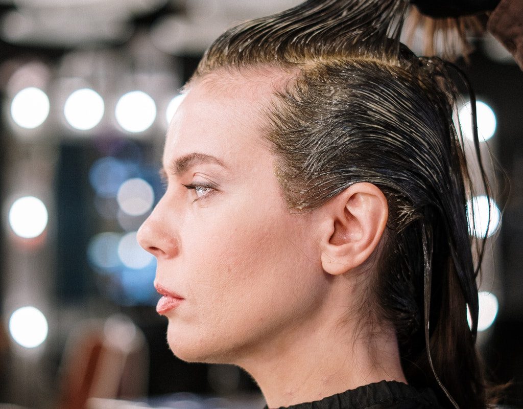 a lady getting her hair dyed