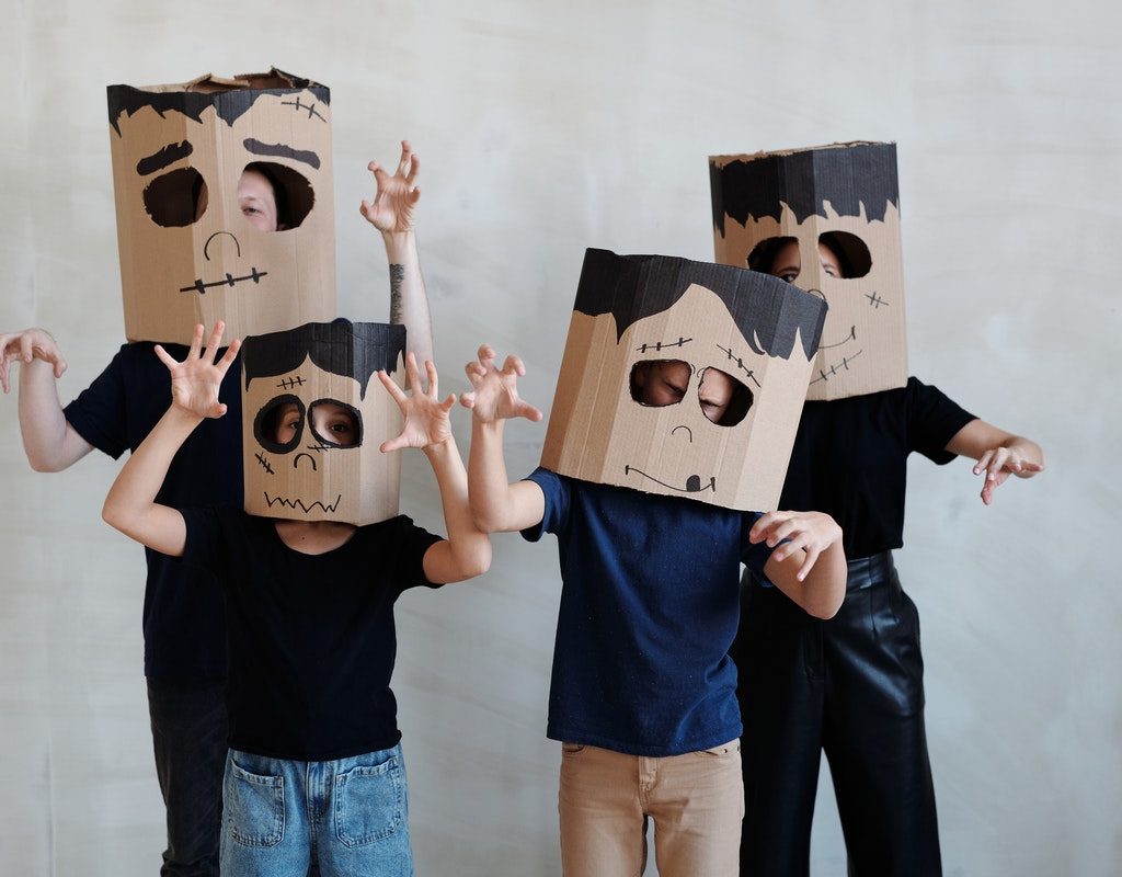 family wearing Halloween masks made from boxes