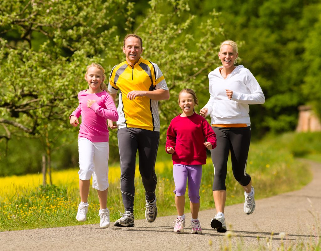 family enjoying a run together in the park