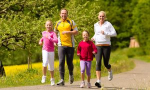 family enjoying a run together in the park