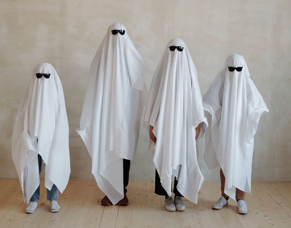 a family dressed as ghosts