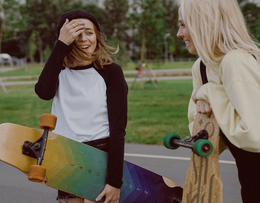 two girls at the park with skateboards