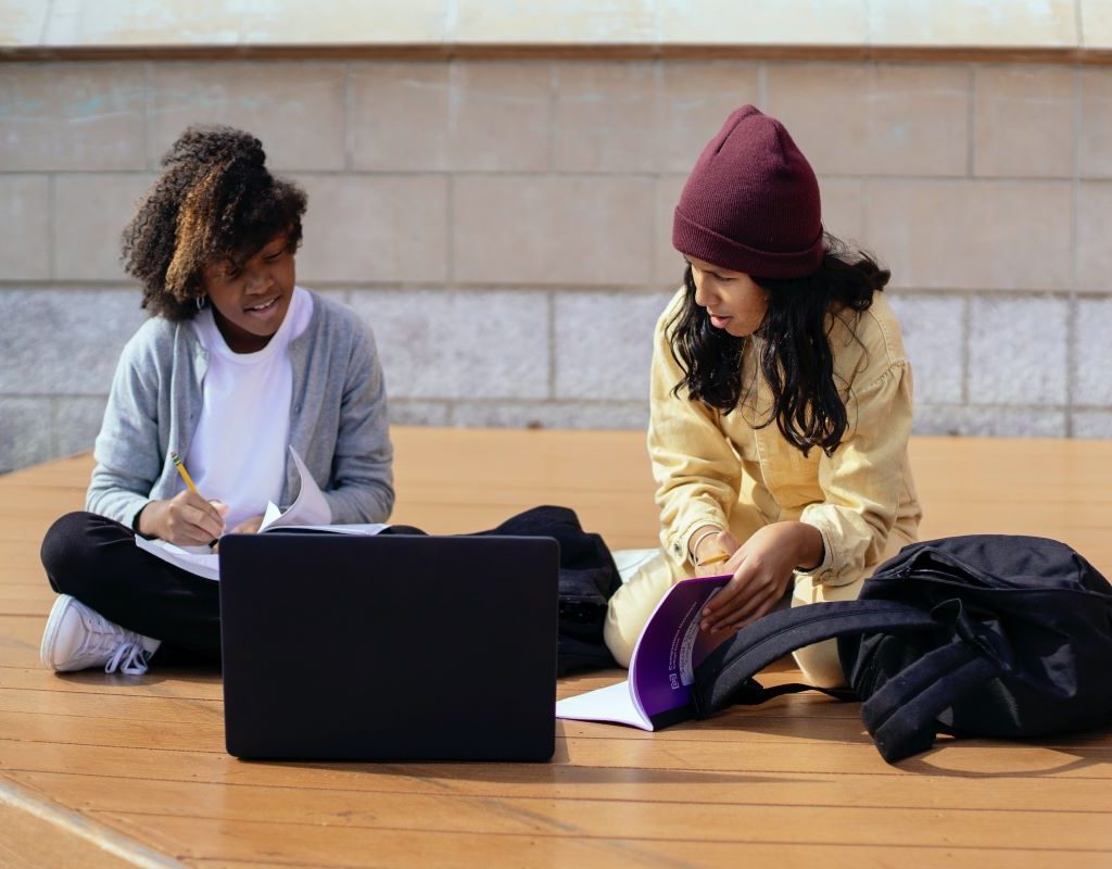 girls working on school work outside
