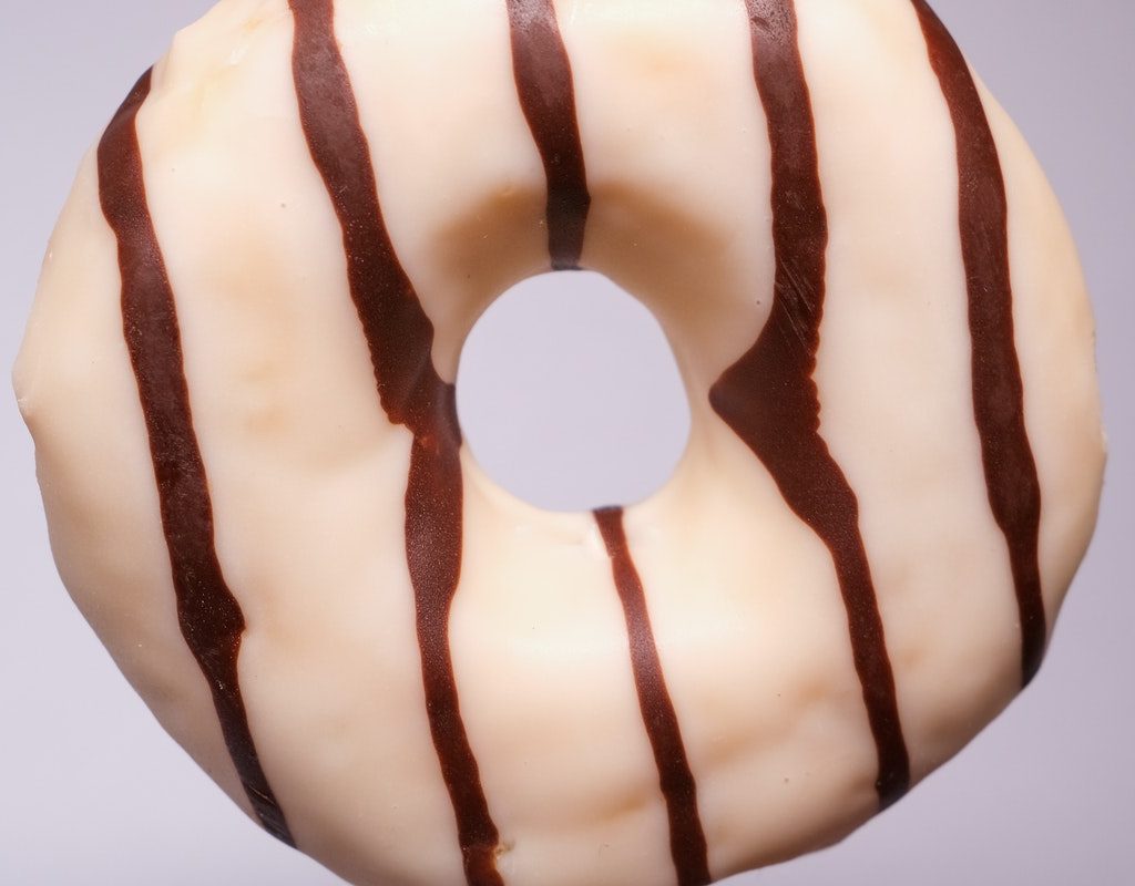 vanilla and chocolate iced junk food doughnut