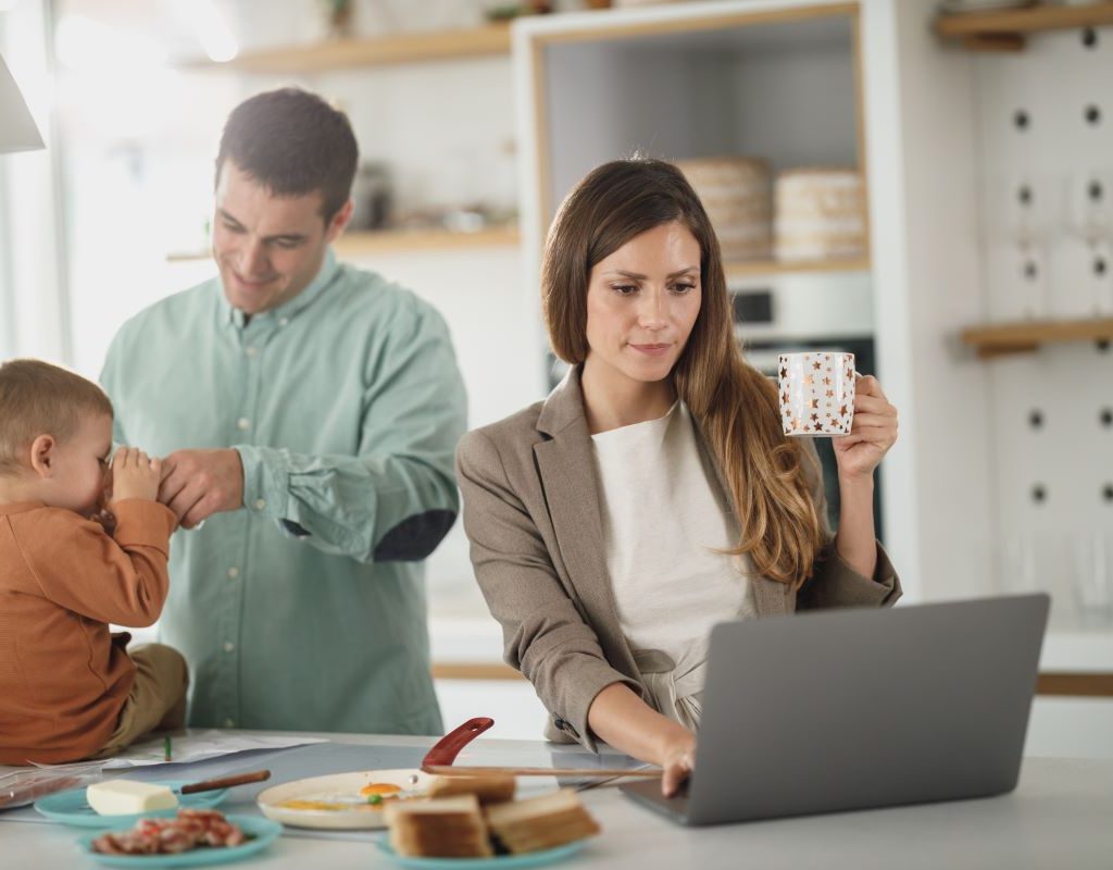 mom looking at computer in the kitchen
