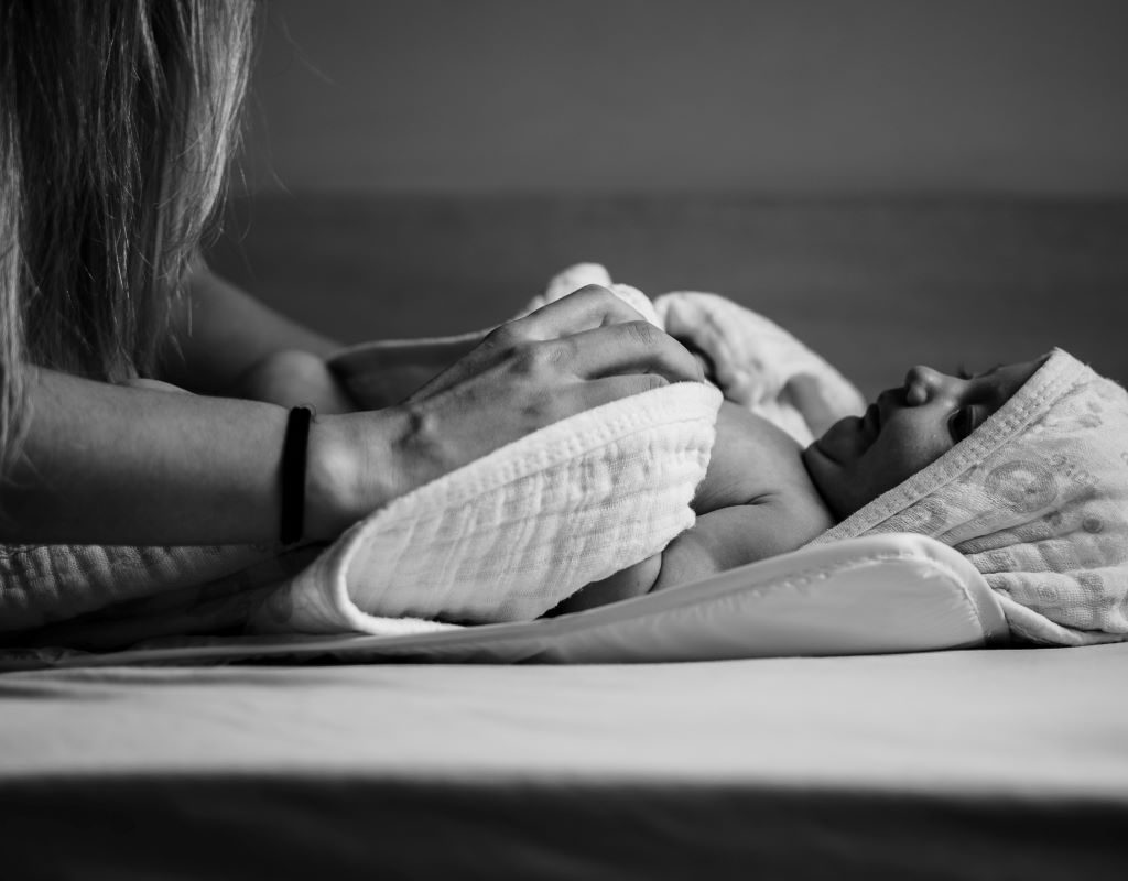 Mom massaging baby before bedtime