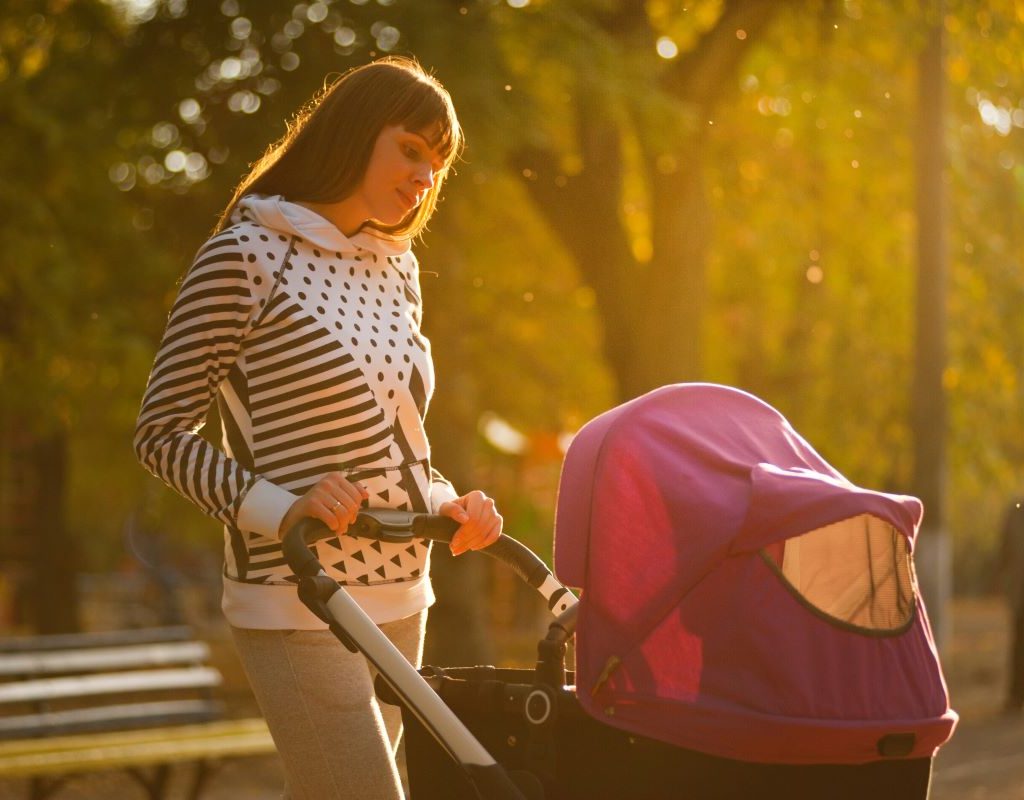 Mom pushing baby buggy