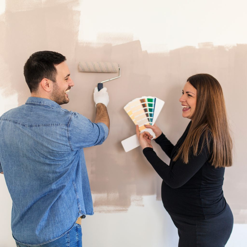 couple painting a nursery