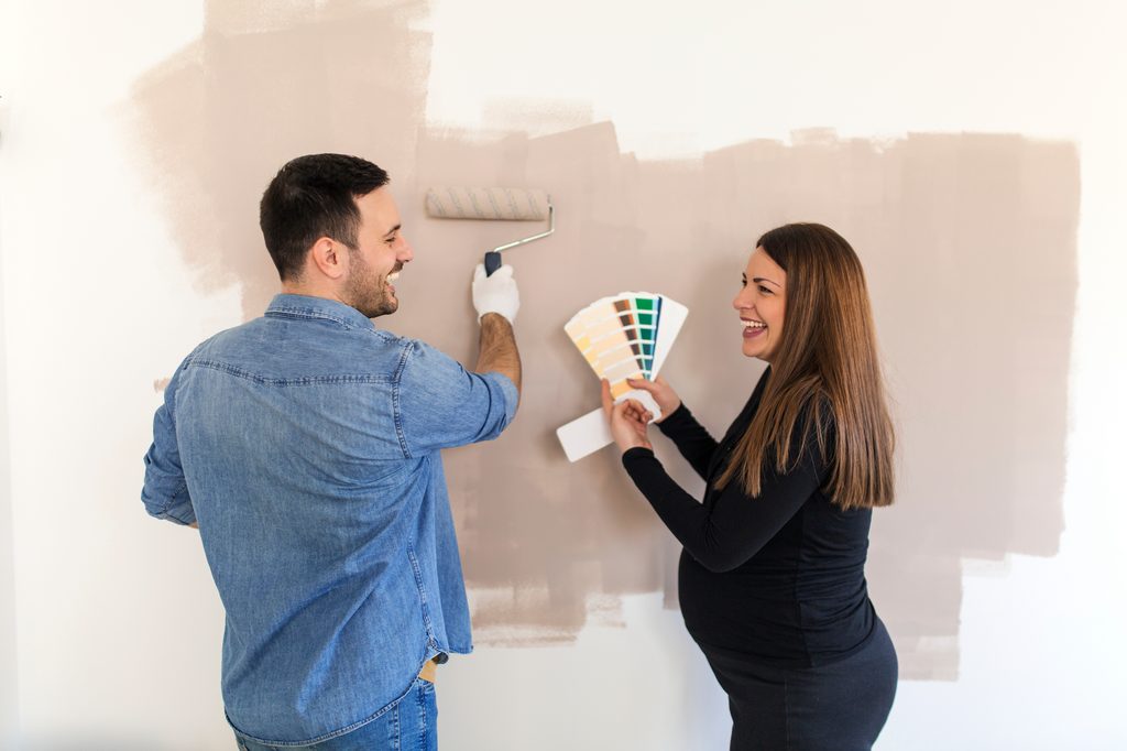 Couple painting a nursery