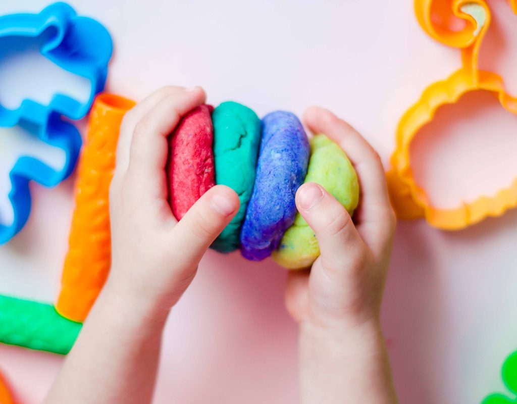 Little hands having fun playing with homemade playdough