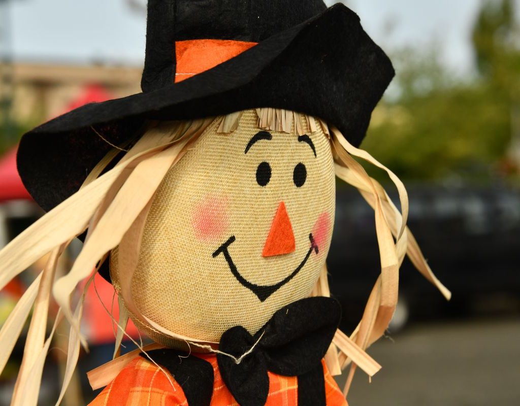 Scarecrow witch sitting outside.