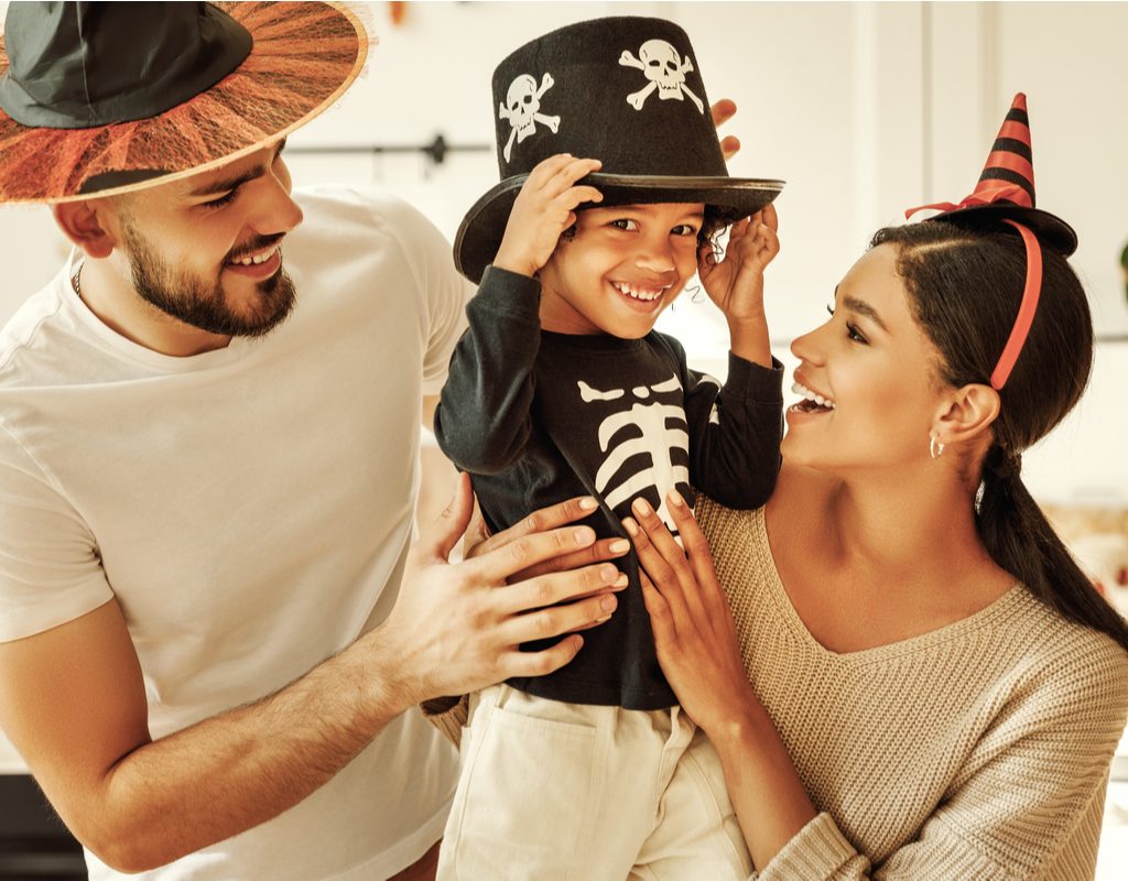 A family dressed in Halloween hats.