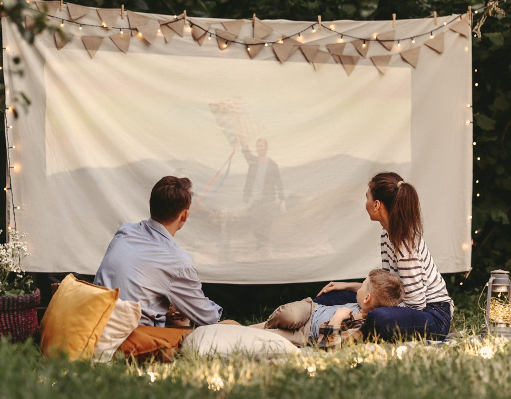 A family enjoying an outdoor movie night.