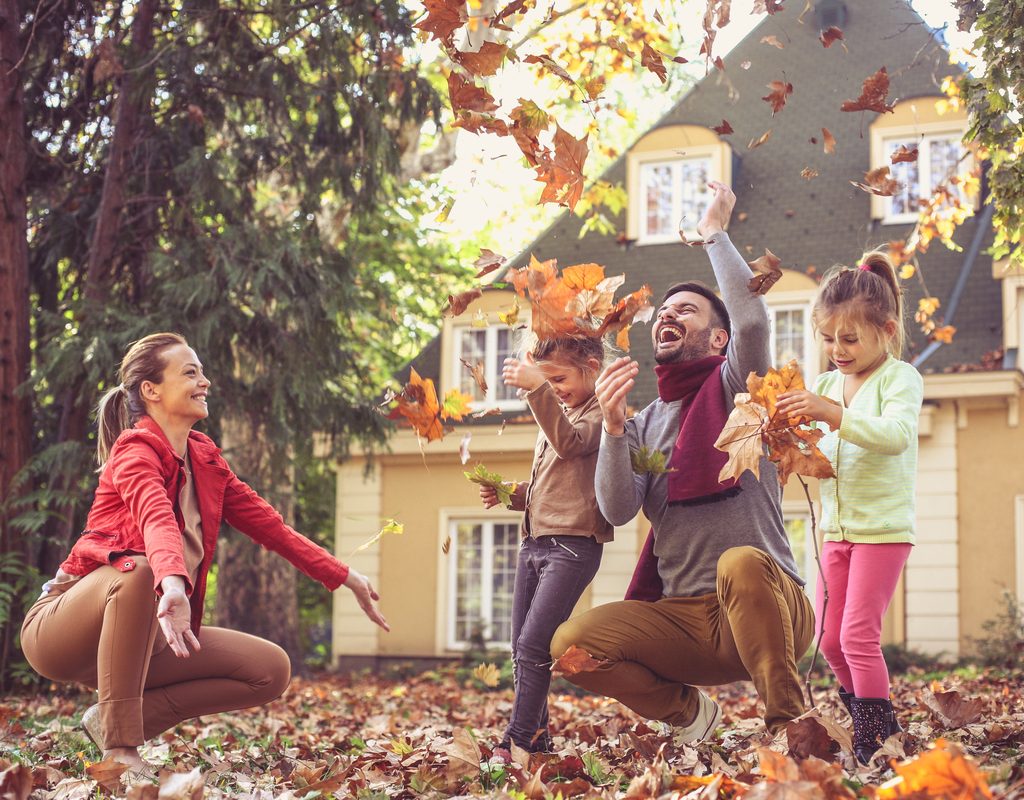 A family having fall fun in the backyard.