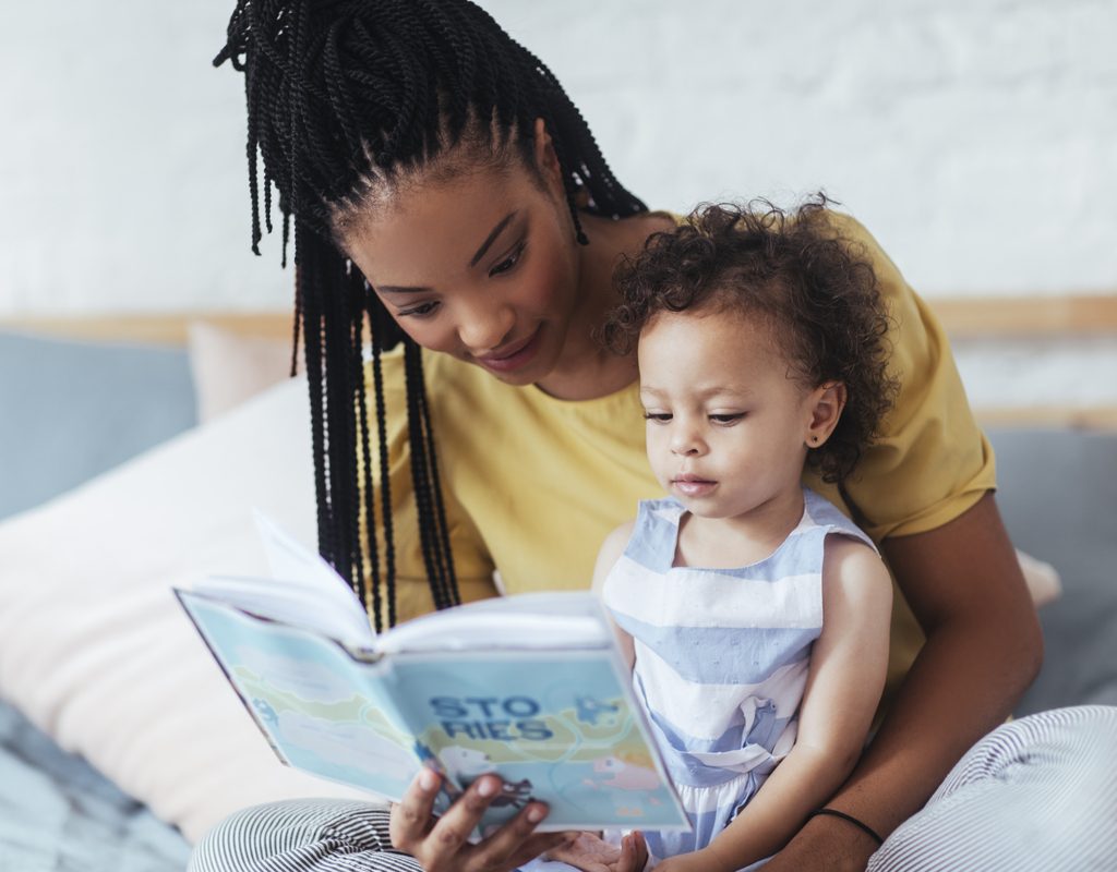 A mother reading to her toddler.