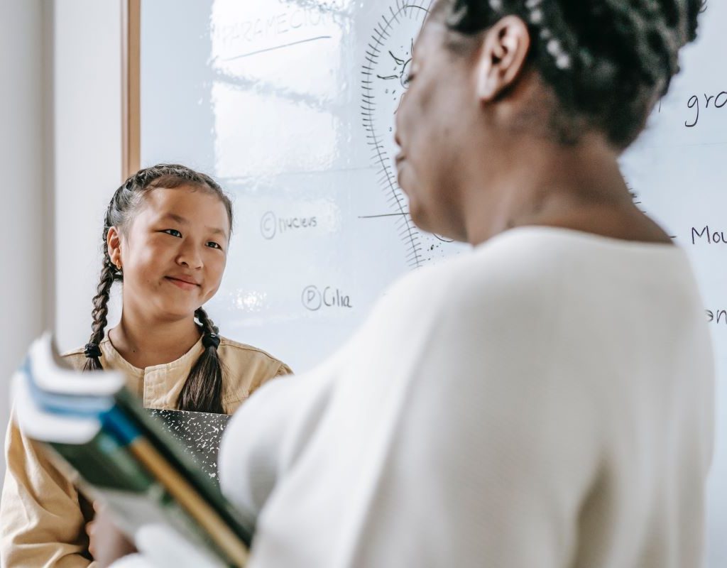 Student talking with teacher