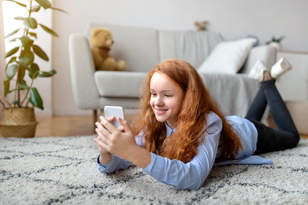 Teen on social media on her smartphone