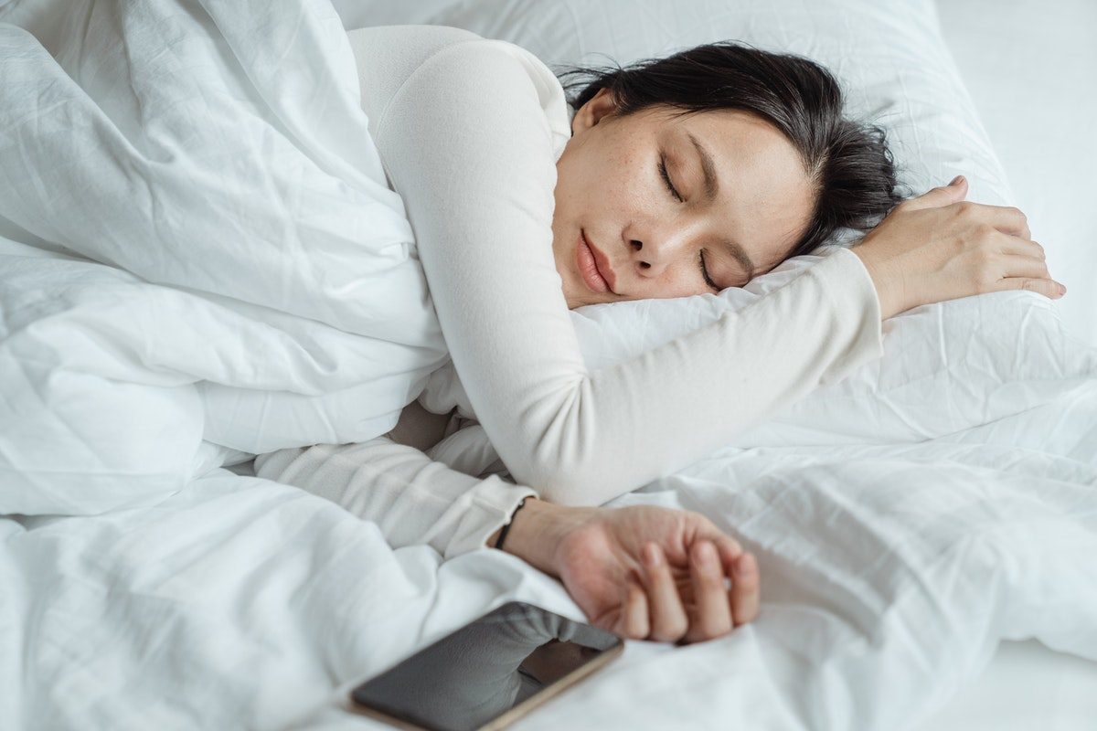 lady sleeping with cell phone nearby