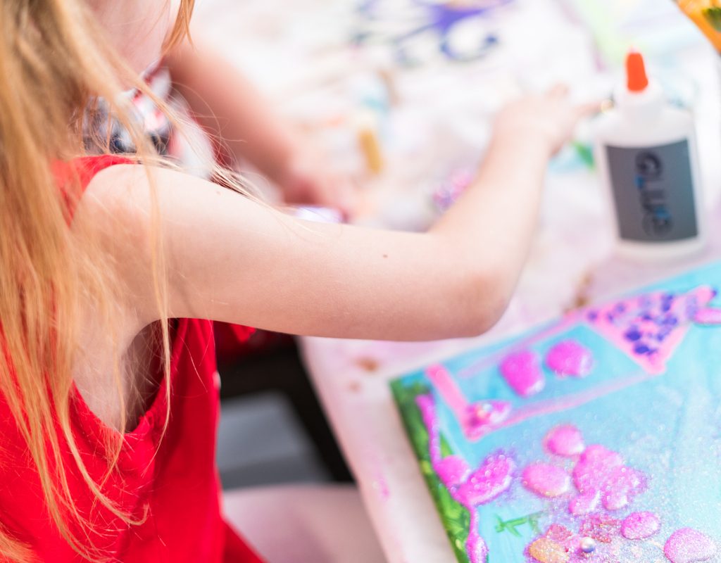Child painting at an art-themed painting party
