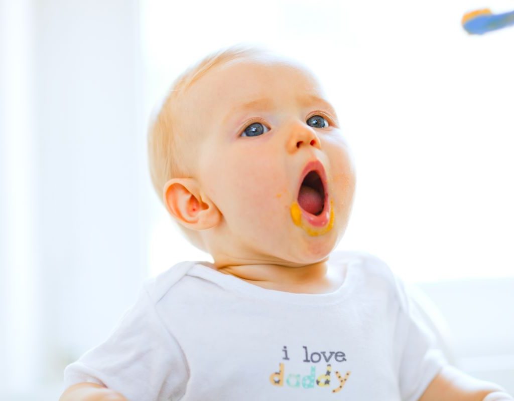 Baby opens mouth at the sight of food