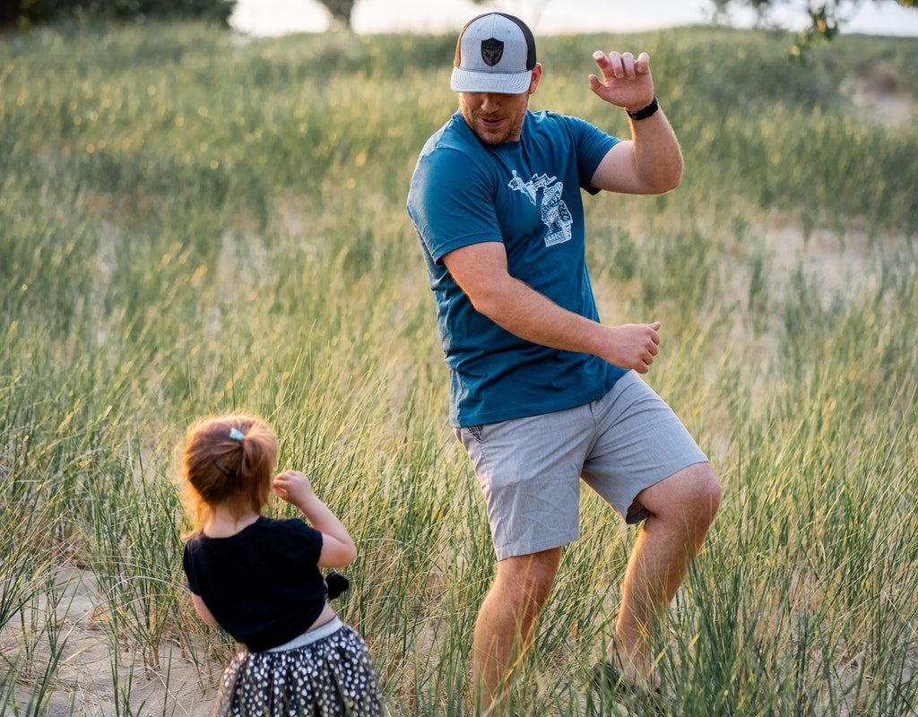 Dad and daughter dancing outside