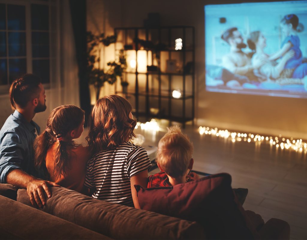 Family watching a movie together for a family fun night
