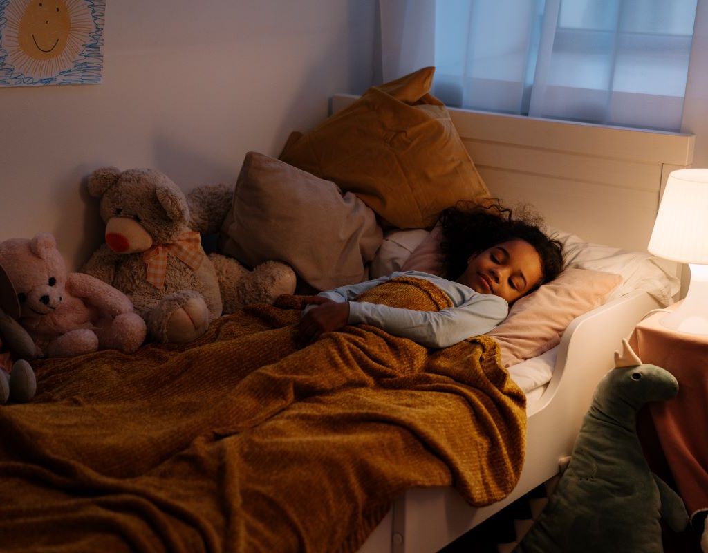 little girl sleeping in toddler bed