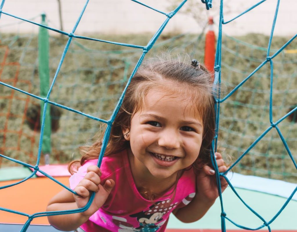 little girl jumping on trampoline