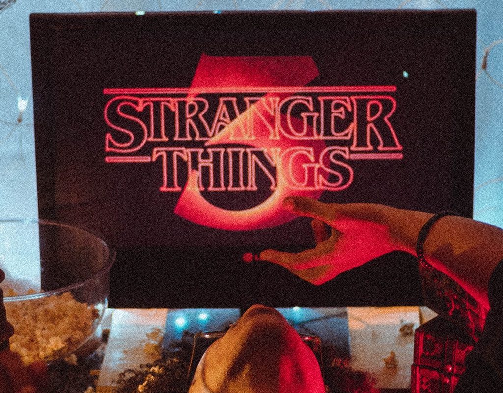 Person watching Stranger Things on television