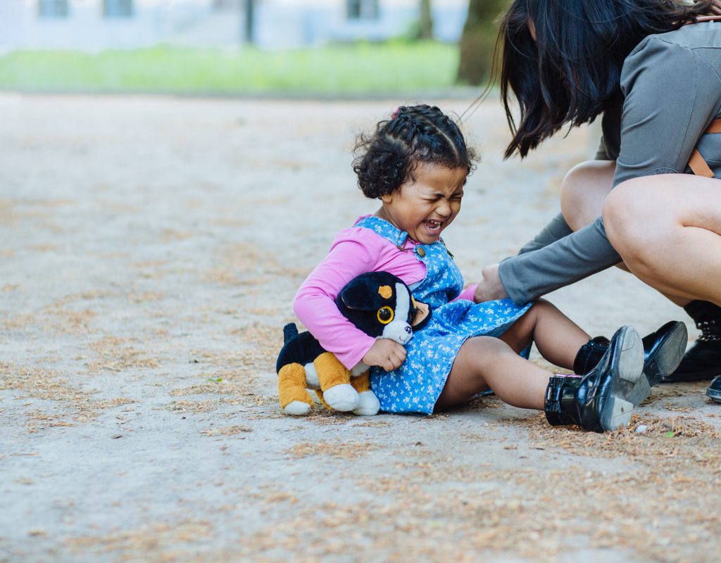 A toddler throwing a fit at a park.