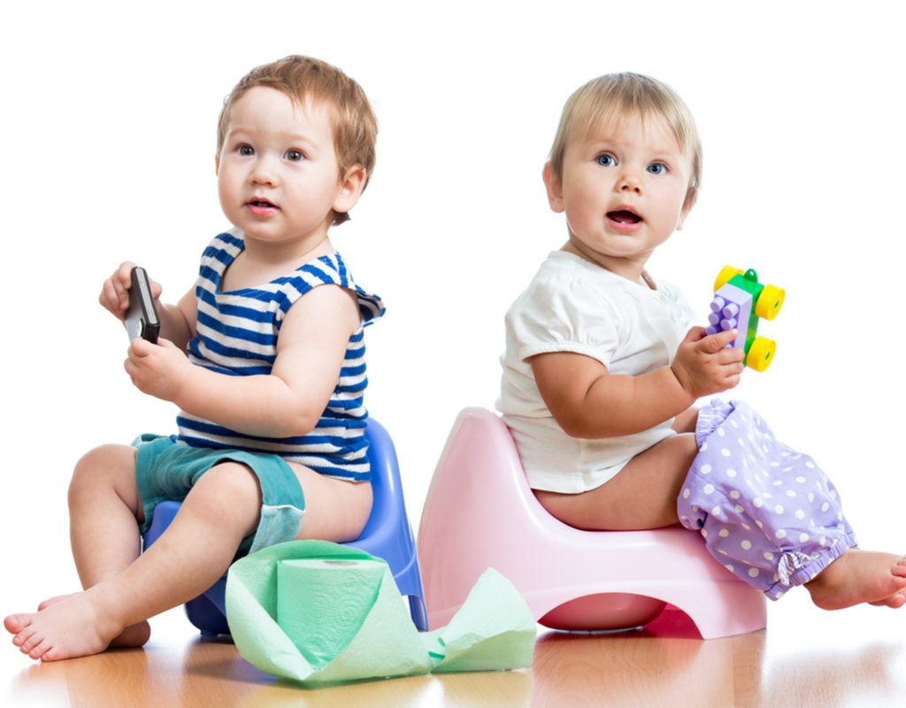 A couple of toddlers on the potty.