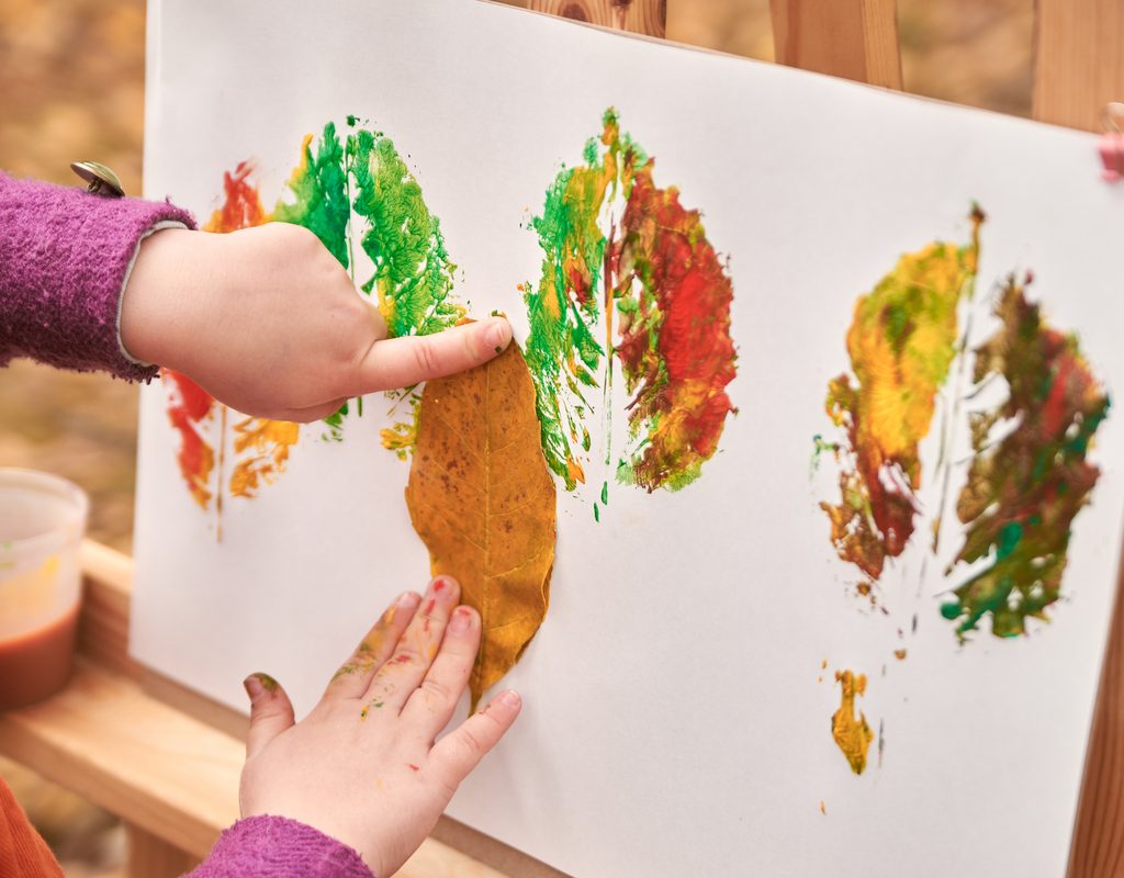 A child making a leaf painting