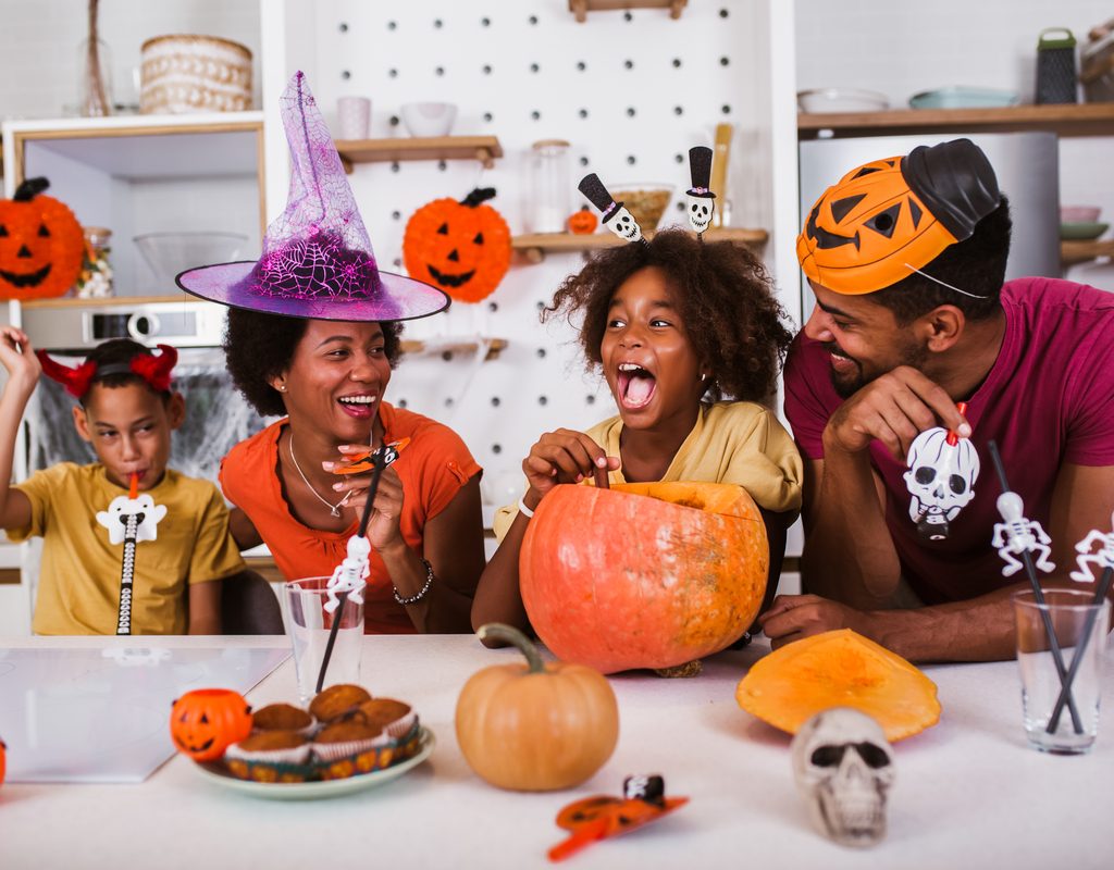 A family doing a Halloween craft.