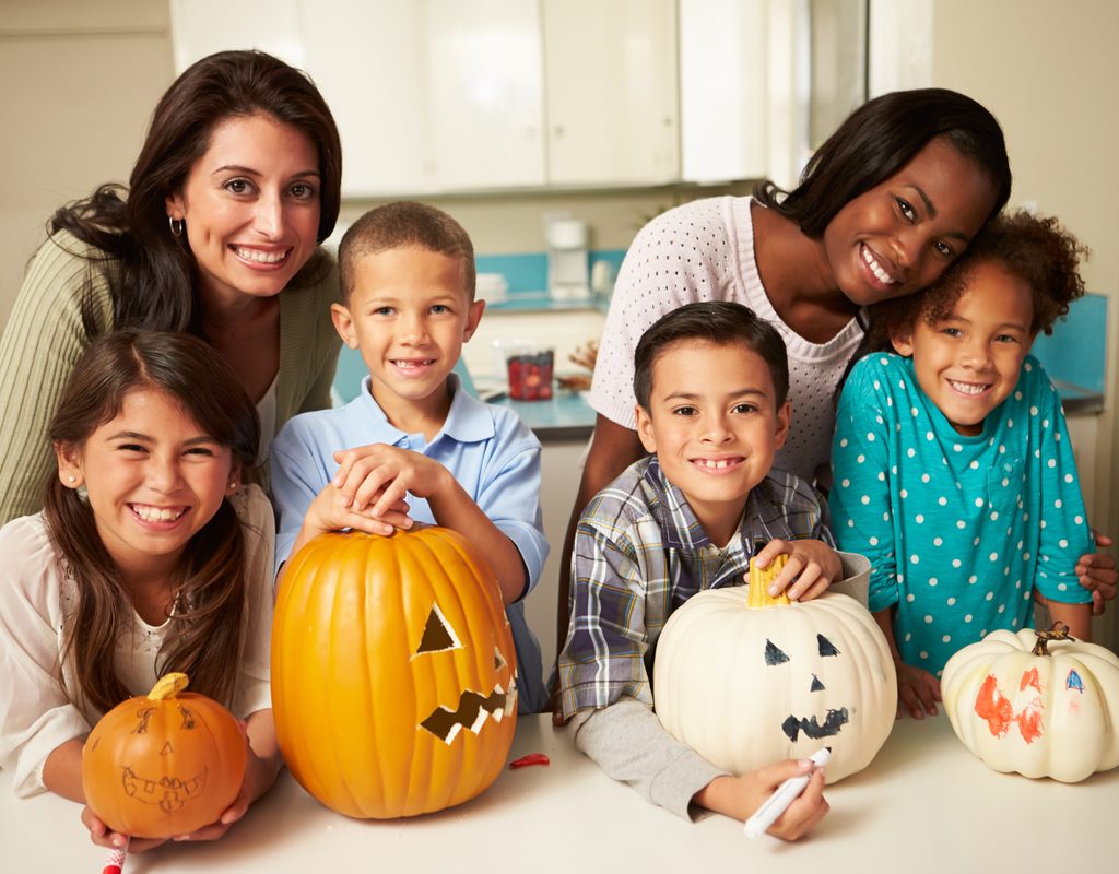 A couple of families enjoying Halloween crafts together.