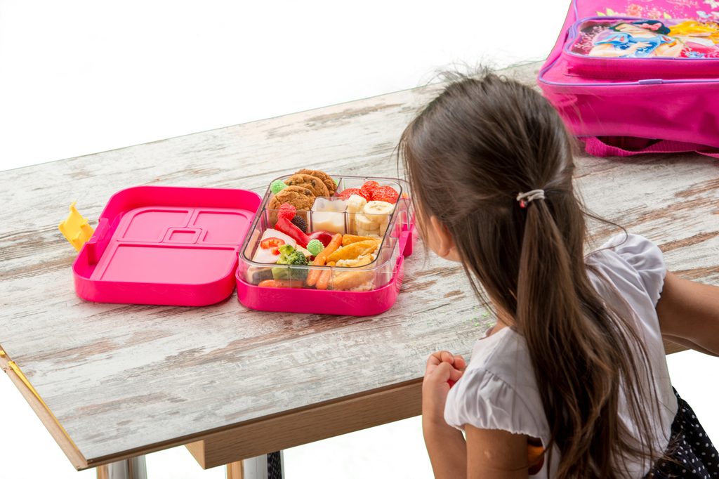 A child eating her school lunch.