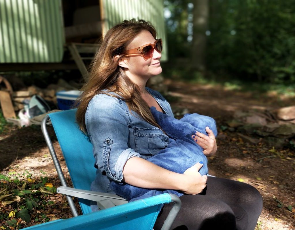 Mom sitting in chair breastfeed baby