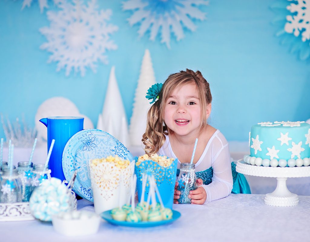 Happy little girl ready for a Frozen-themed birthday party