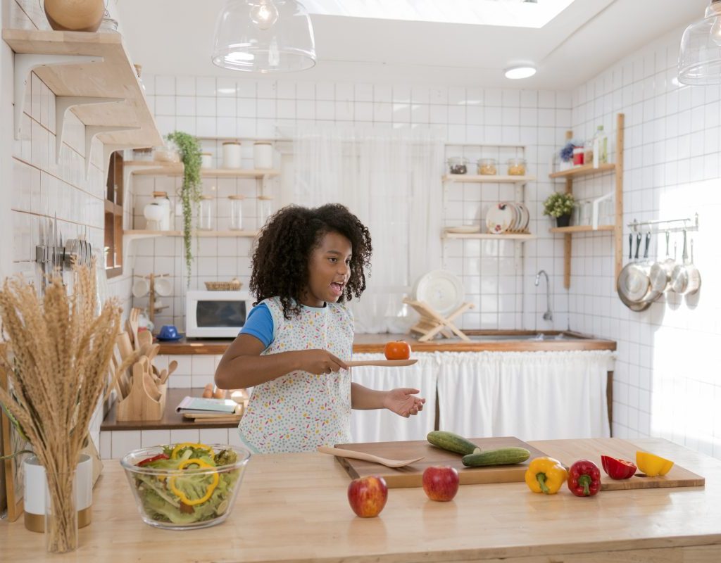 A kid making themselves some food in the kitchen.