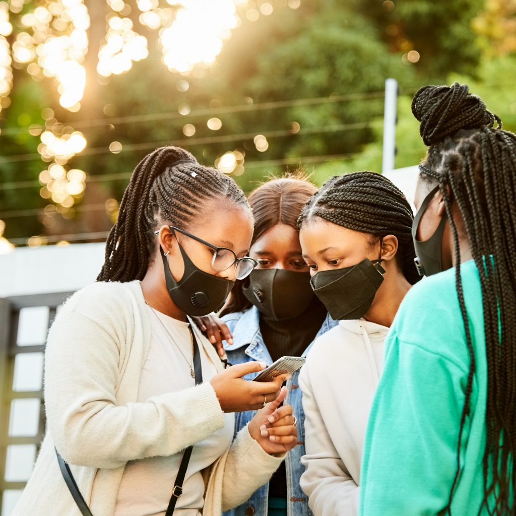 teen-girls-discuss-coronavirus-looking-at-phones