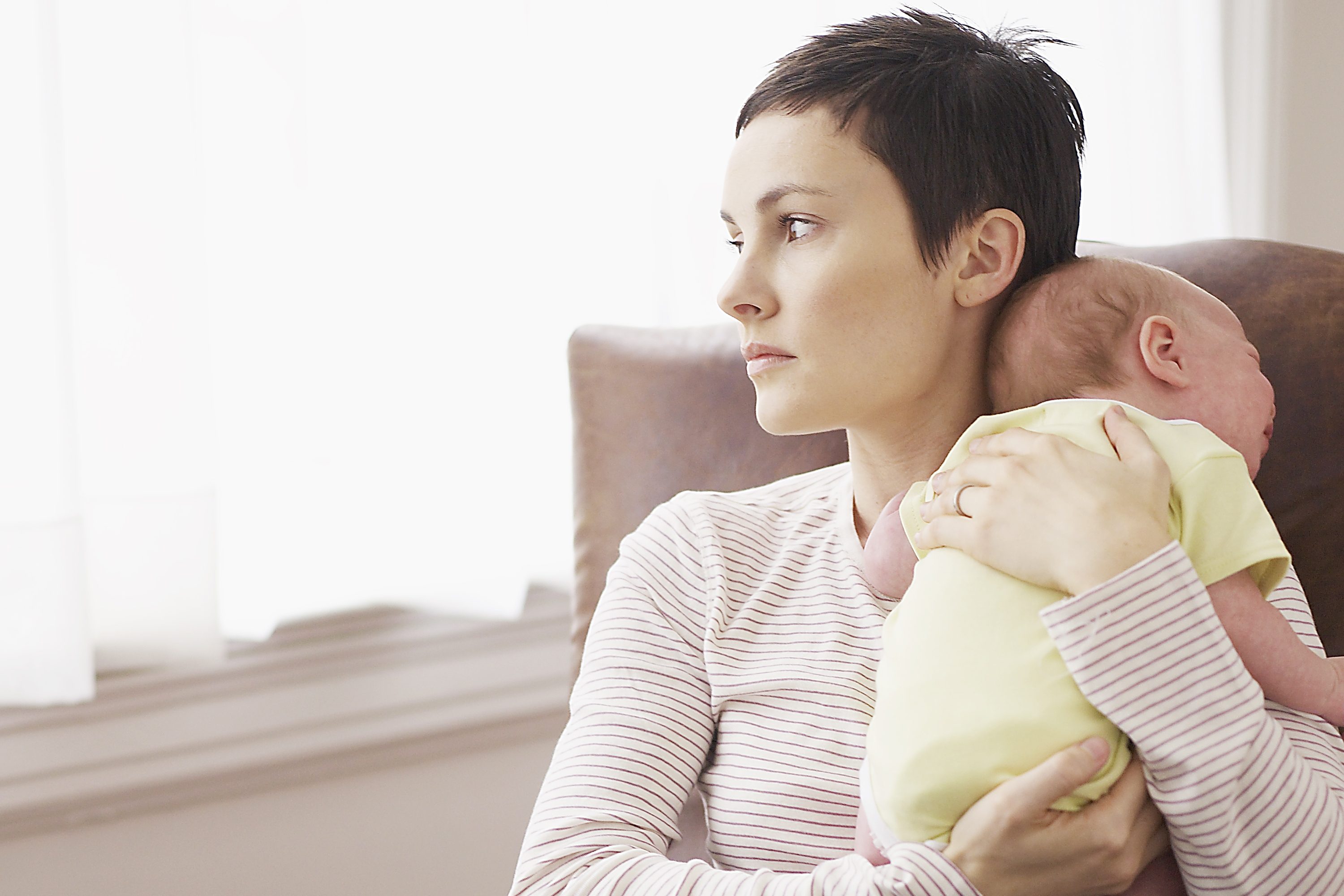 mom-postpartum-depression-looks-out-window
