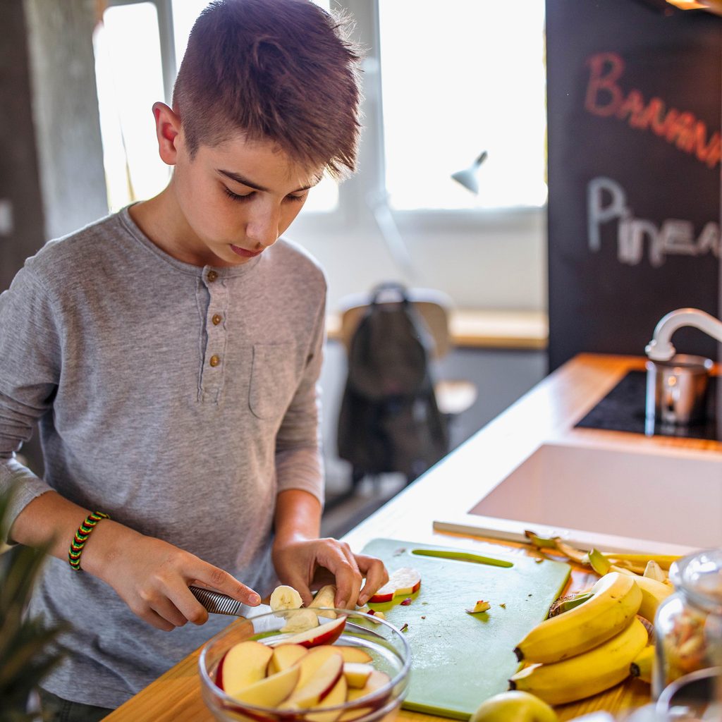 A child making themselves a snack.