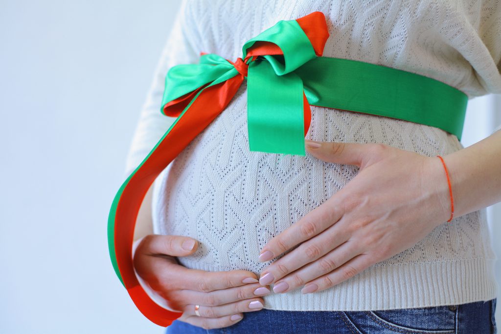 Baby bump wrapped up like a Christmas present.