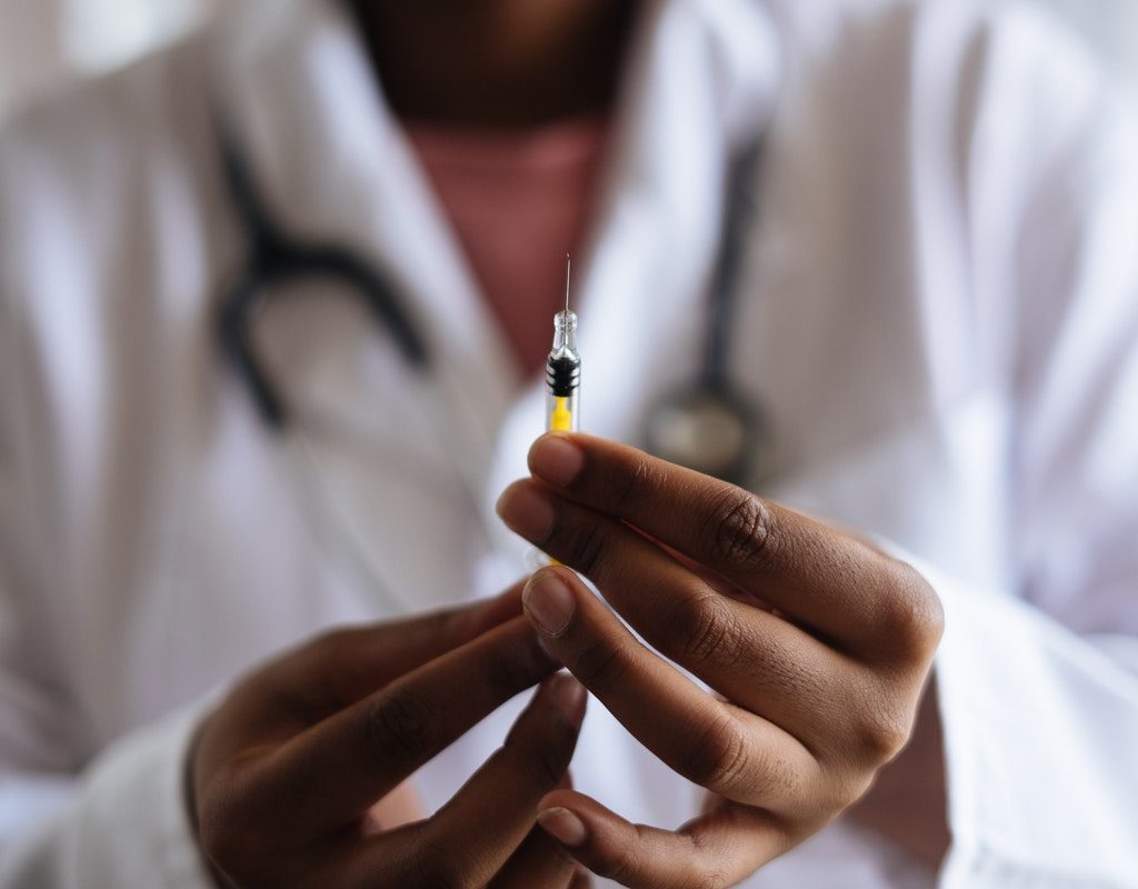 A doctor holding a syringe