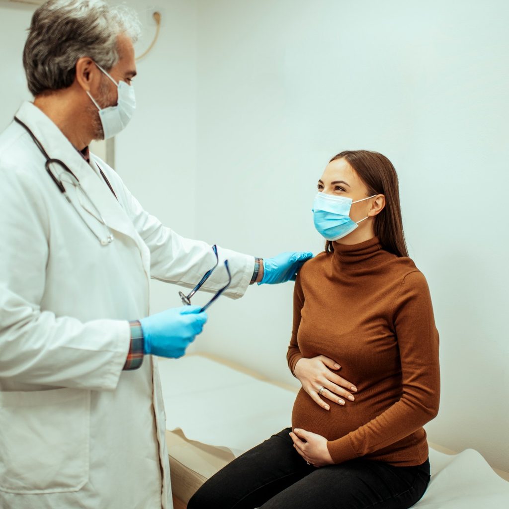 Pregnant mom and doctor in office