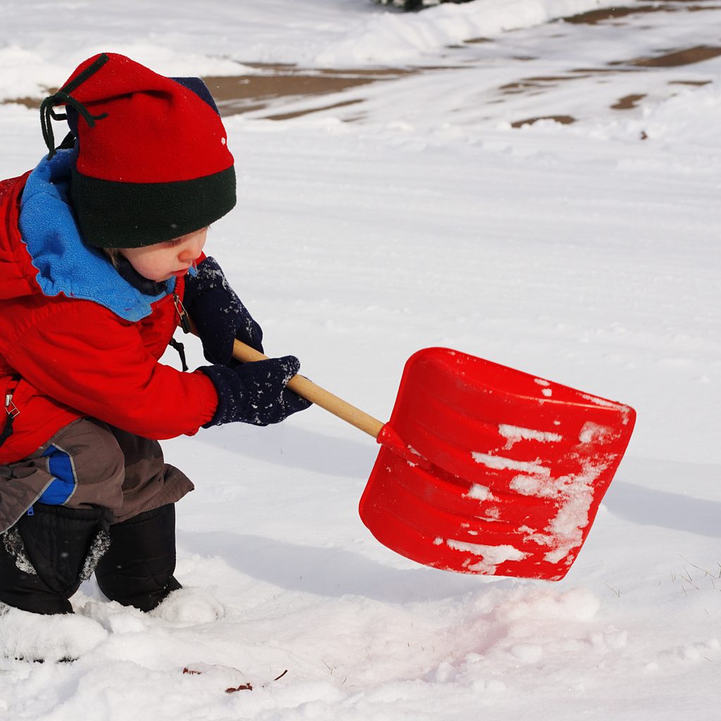 Toddler having fun outside in the snow