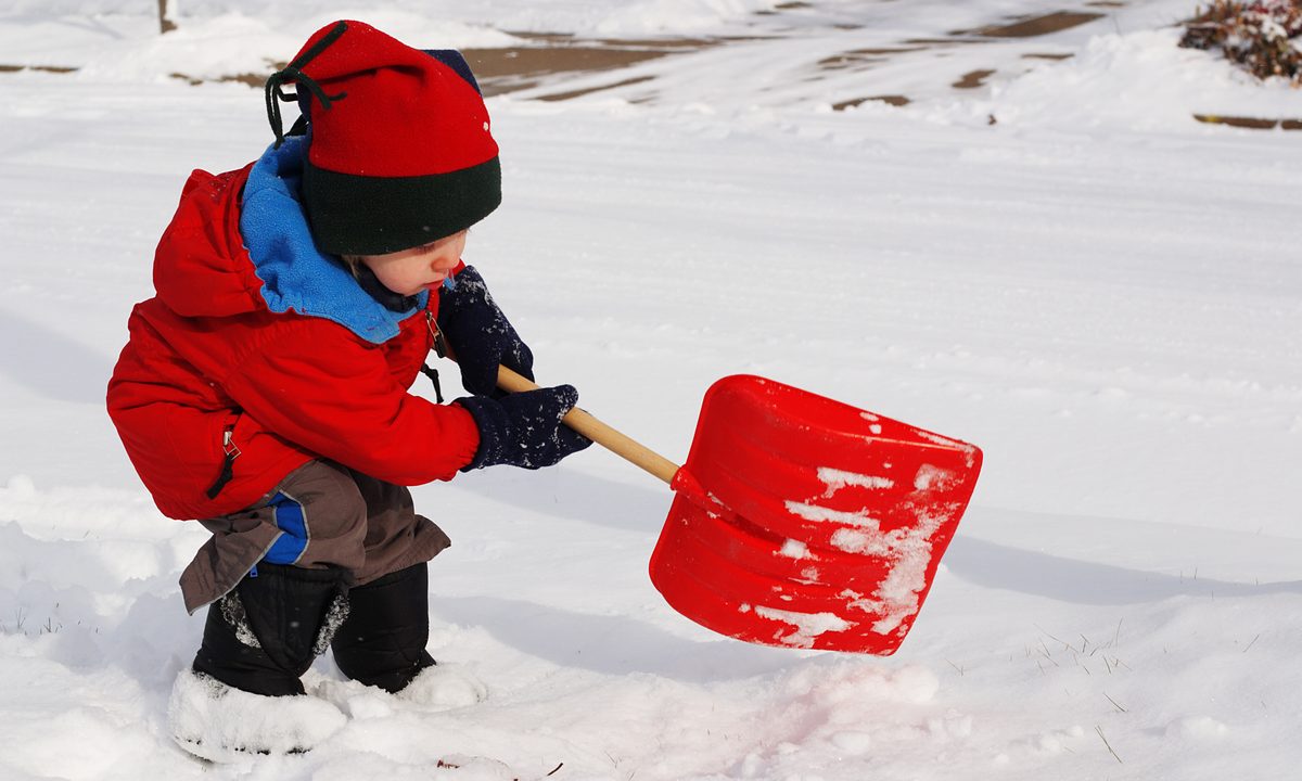 Toddler having fun outside in the snow