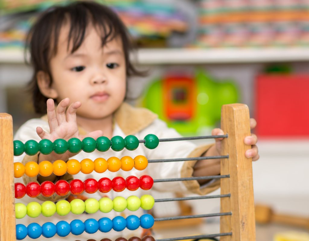 toddler learning to count with an abacus